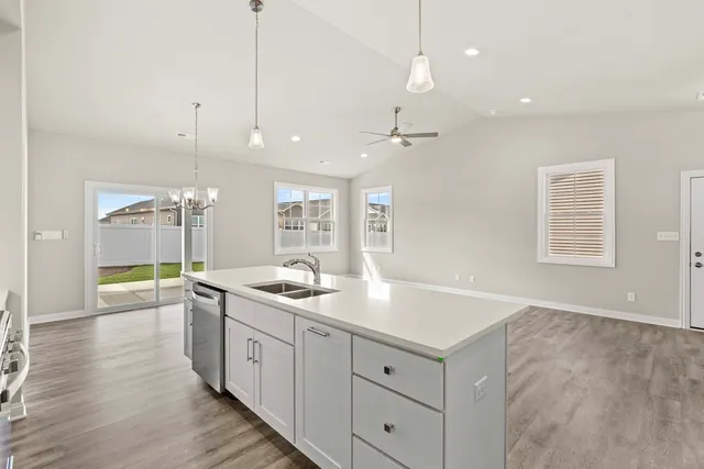 a large kitchen with sink and view of living room