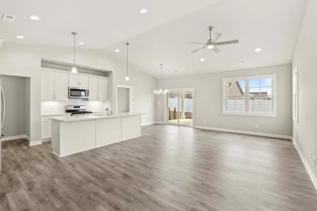 a living room with kitchen island furniture and a kitchen view