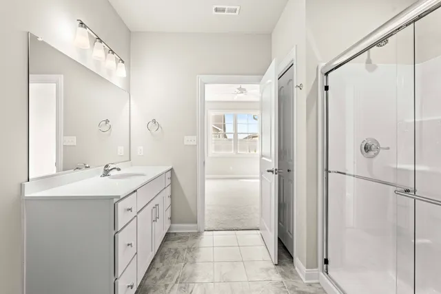 a bathroom with a glass shower door