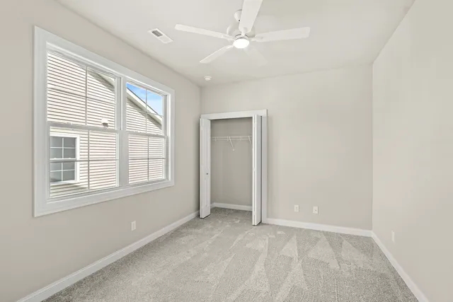 an empty room with windows and entrance