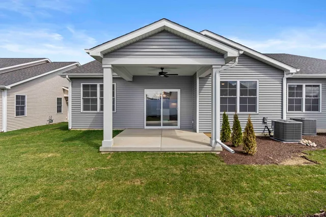 a kitchen with kitchen island white cabinets and stainless steel appliances