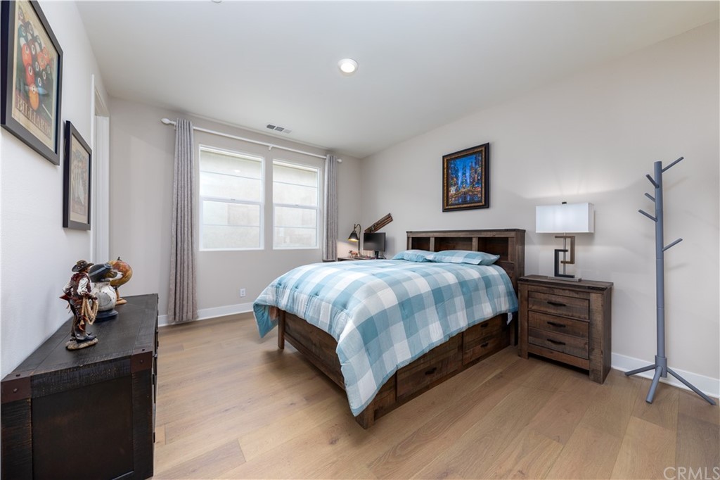 56 Swift Irvine, CA 92618 - Photo 11 of 43 a bedroom with a bed and wooden floor