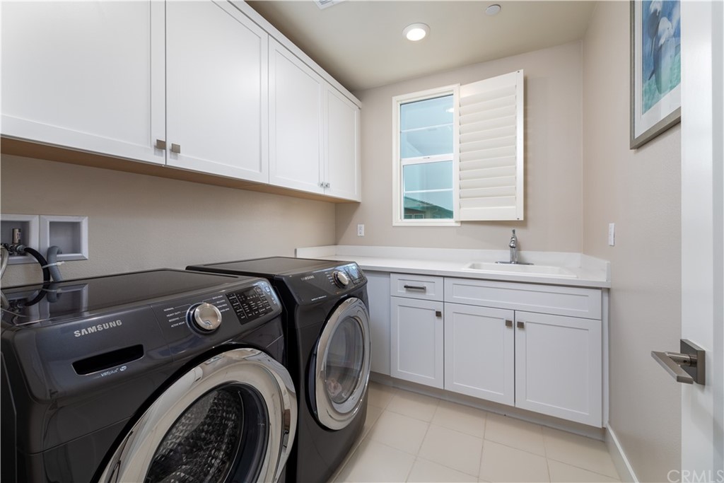 56 Swift Irvine, CA 92618 - Photo 9 of 43 a utility room with sink dryer and washer
