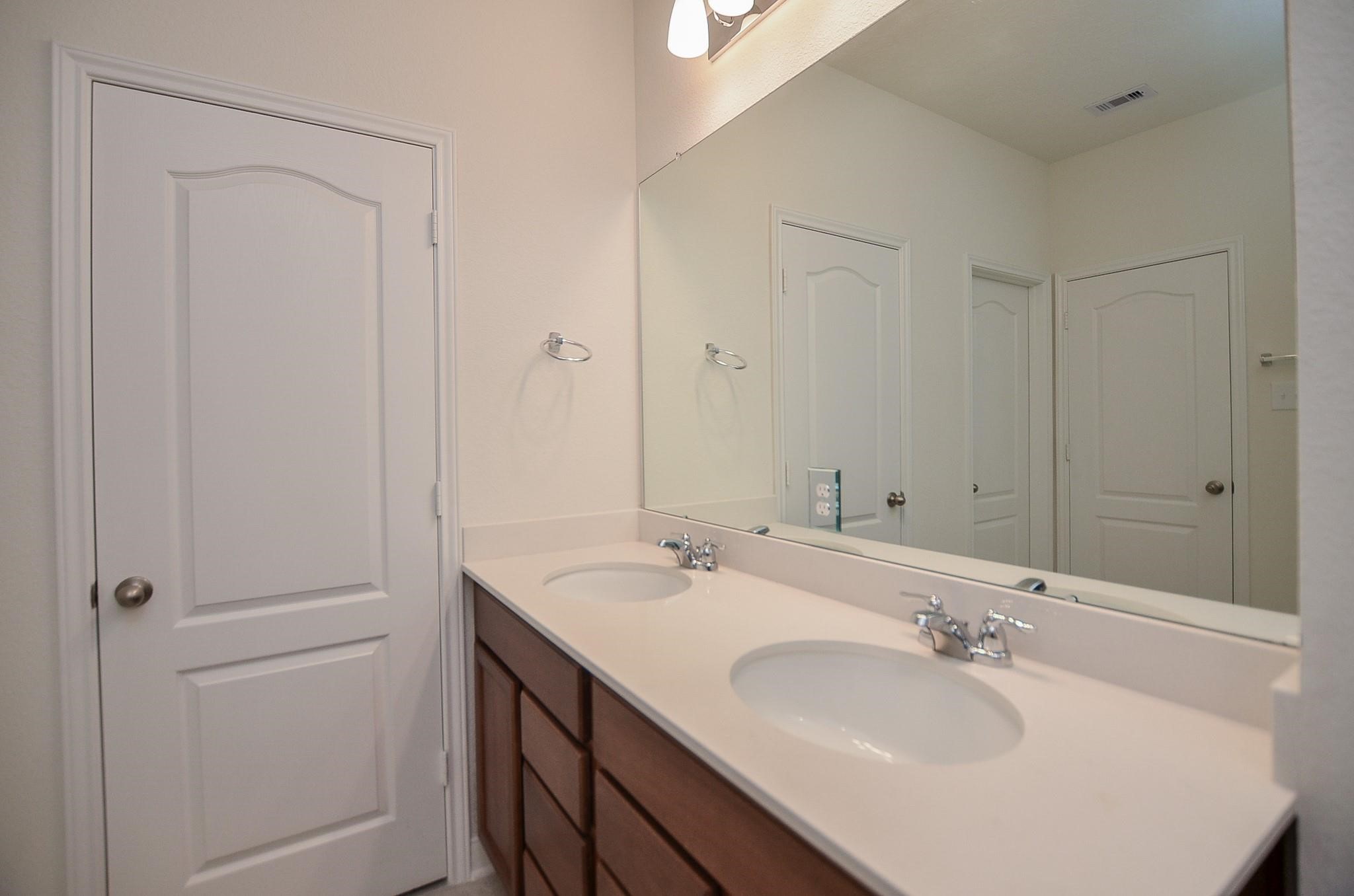 20907 Filbert Lane Katy, TX 77449 - Photo 23 of 43 a bathroom with 2 sink and a mirror