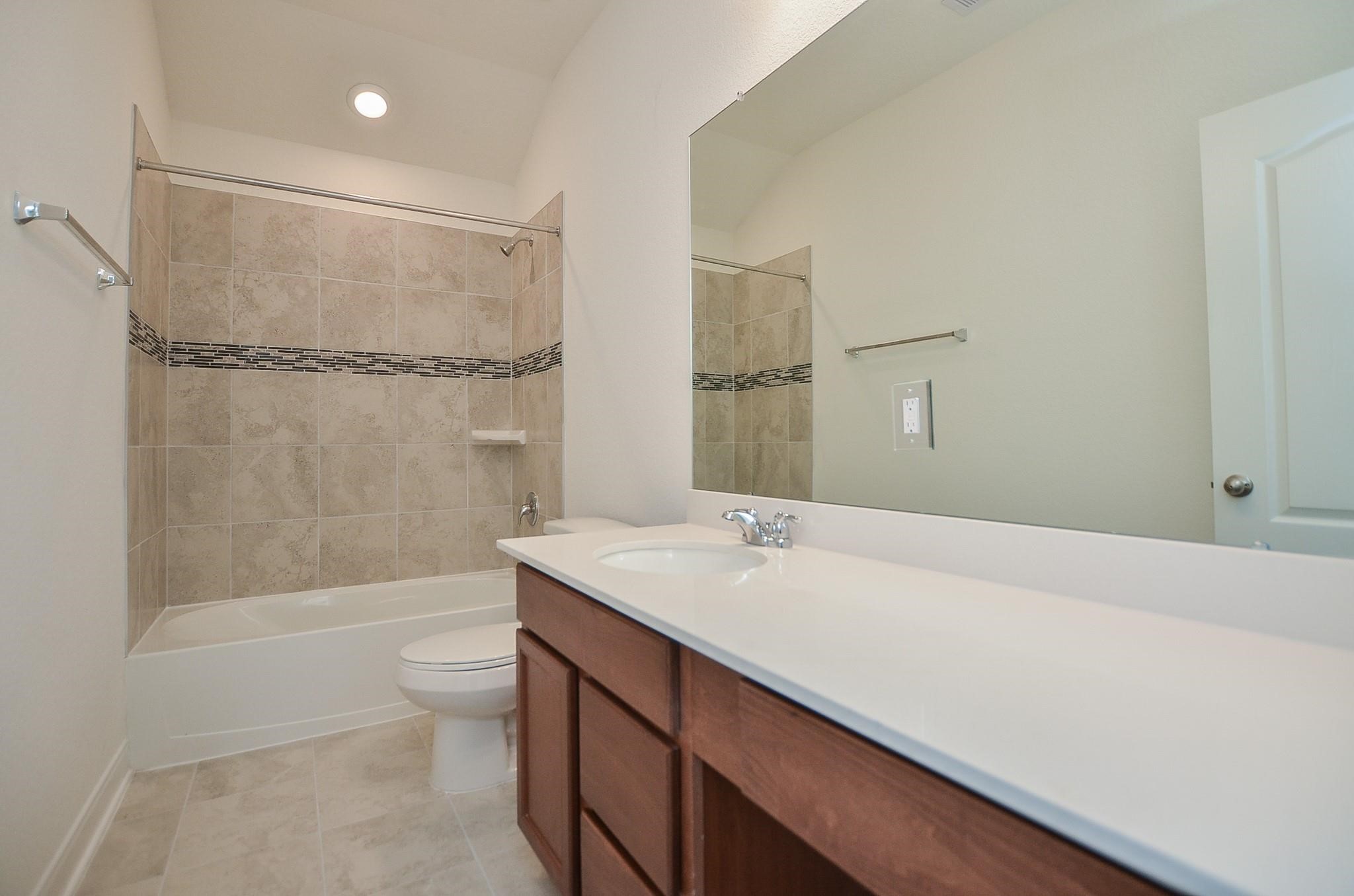 20907 Filbert Lane Katy, TX 77449 - Photo 33 of 43 a bathroom with a sink a toilet and shower