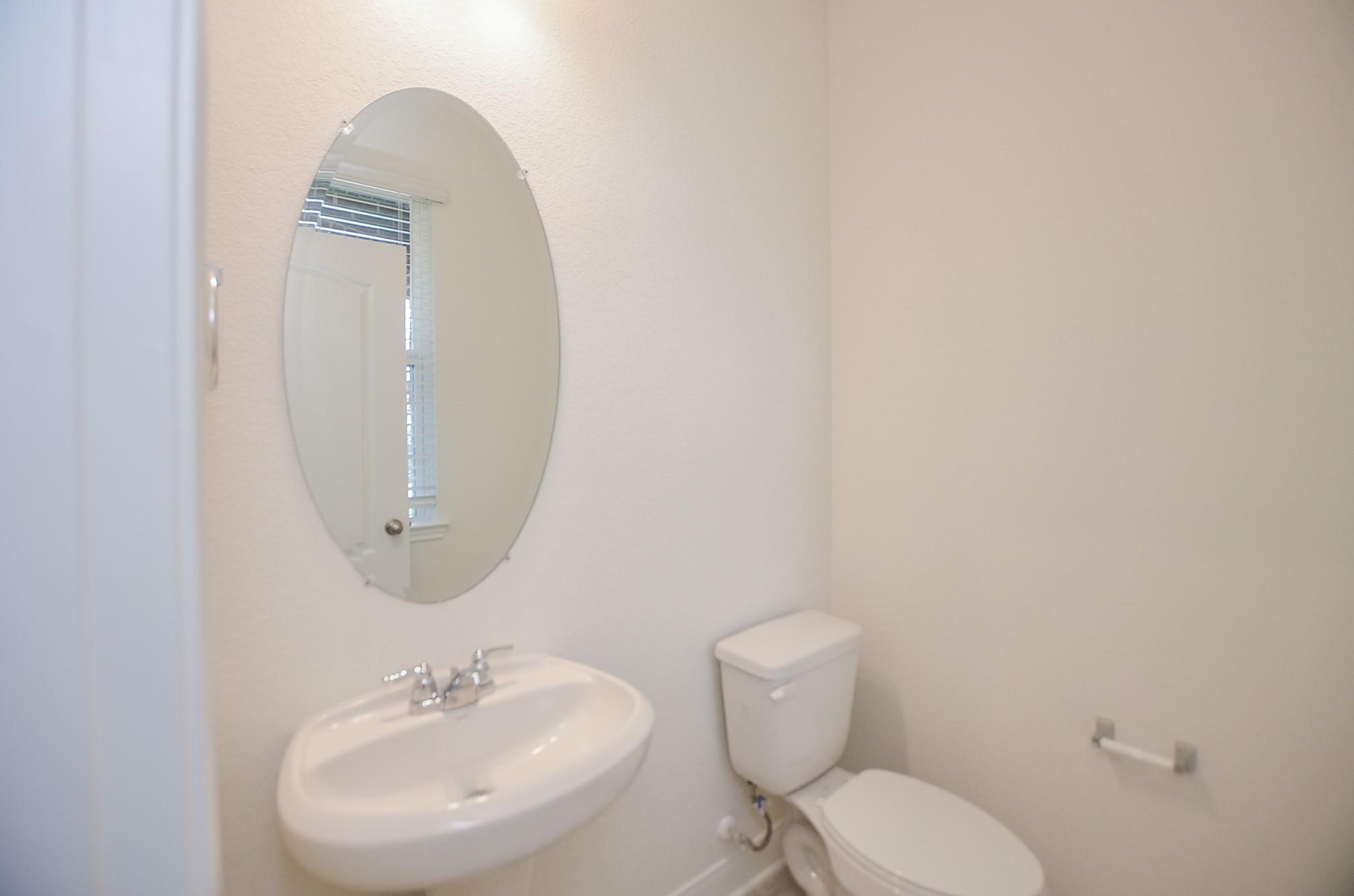20907 Filbert Lane Katy, TX 77449 - Photo 35 of 43 a bathroom with a toilet sink and mirror