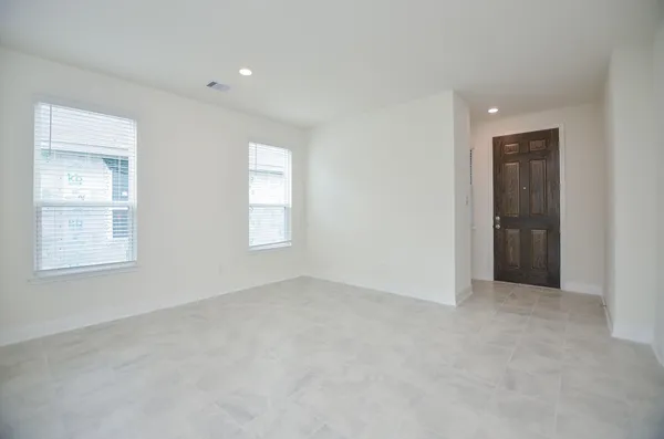 an empty room with windows and entrance