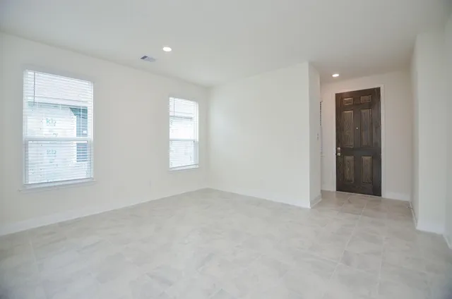 an empty room with windows and entrance