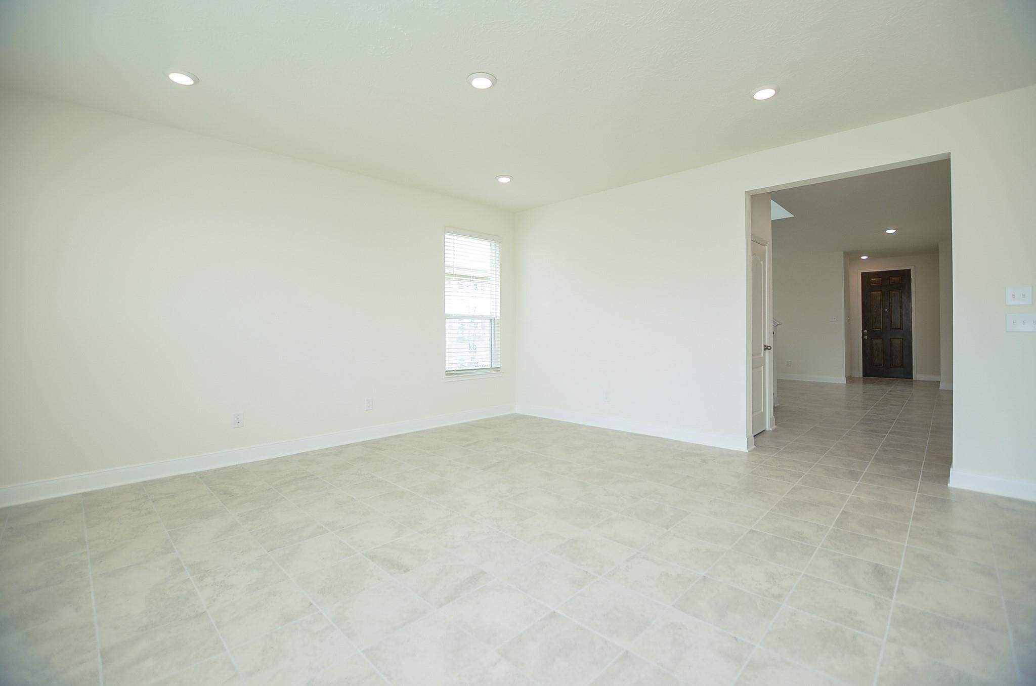 20907 Filbert Lane Katy, TX 77449 - Photo 8 of 43 an empty room with windows and entrance to other room