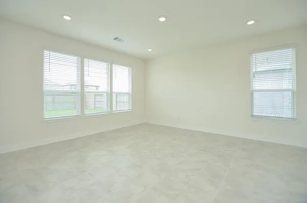 a view of a kitchen with kitchen island a sink wooden floor and a large window