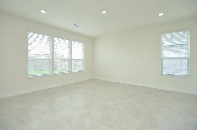 a view of a kitchen with kitchen island a sink wooden floor and a large window