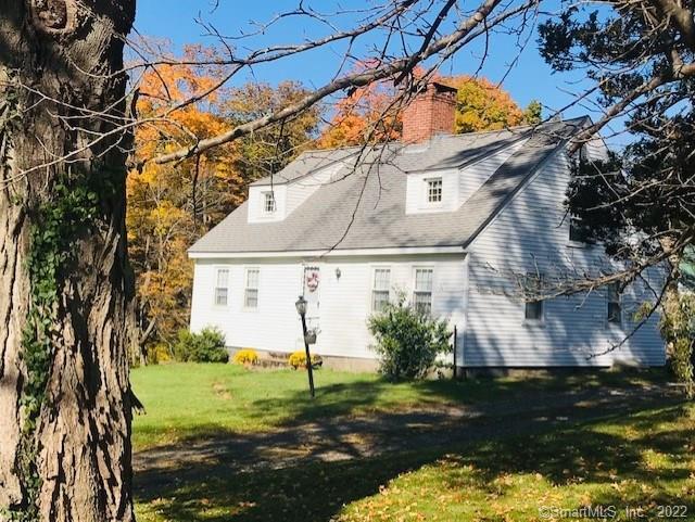 a view of a white house with a yard