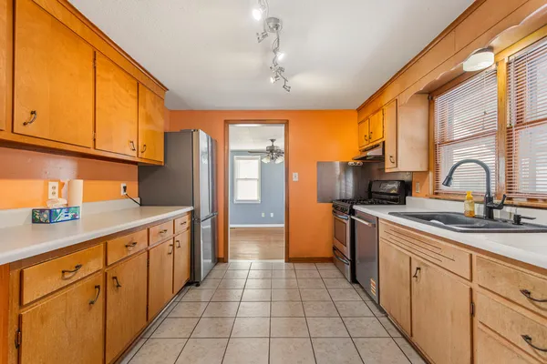 a kitchen with stainless steel appliances granite countertop a sink and cabinets