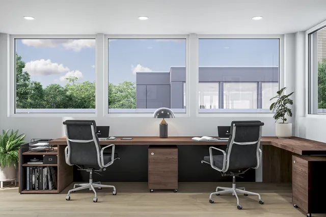 a view of a workspace with furniture and a window