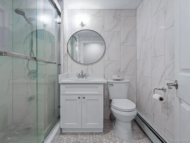 a bathroom with a toilet a sink and mirror