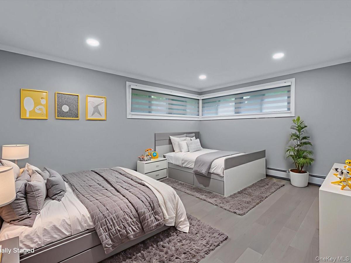 19 Ridge Drive East Roslyn, NY 11576 - Photo 22 of 33 a bedroom with a bed and a couch