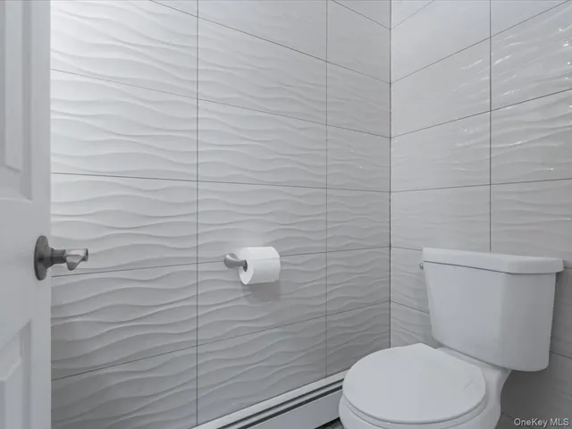 a white toilet sitting next to a bathroom sink