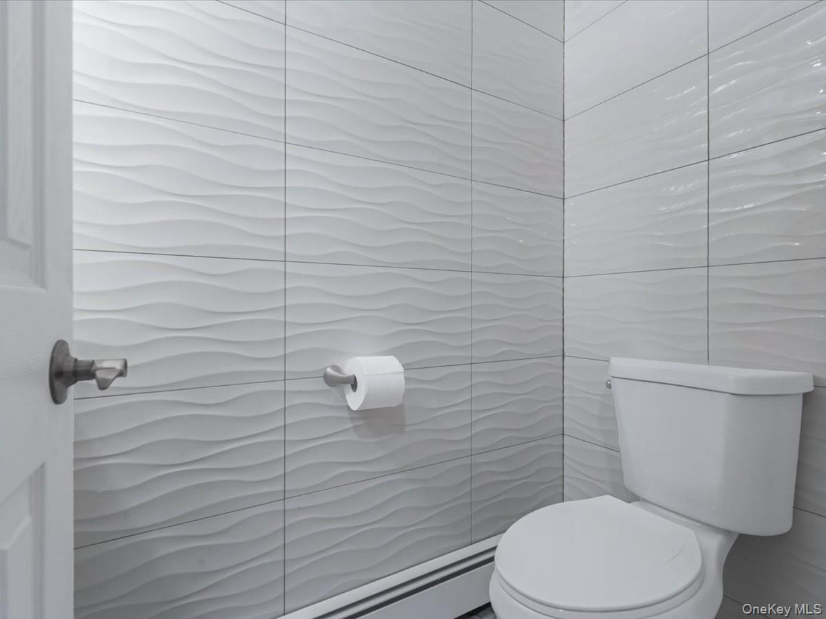 19 Ridge Drive East Roslyn, NY 11576 - Photo 27 of 33 a white toilet sitting next to a bathroom sink