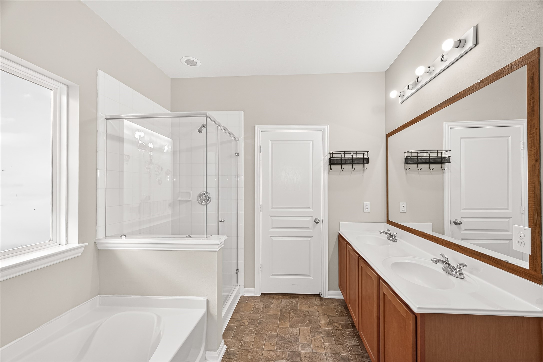 11211 Riata Canyon Drive Cypress, TX 77433 - Photo 16 of 33 a bathroom with a tub sink vanity granite and a shower