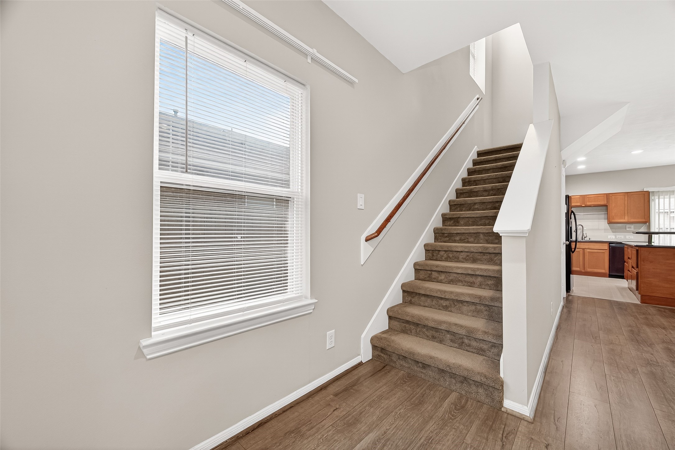 11211 Riata Canyon Drive Cypress, TX 77433 - Photo 19 of 33 a view of an entryway with wooden floor and stairs