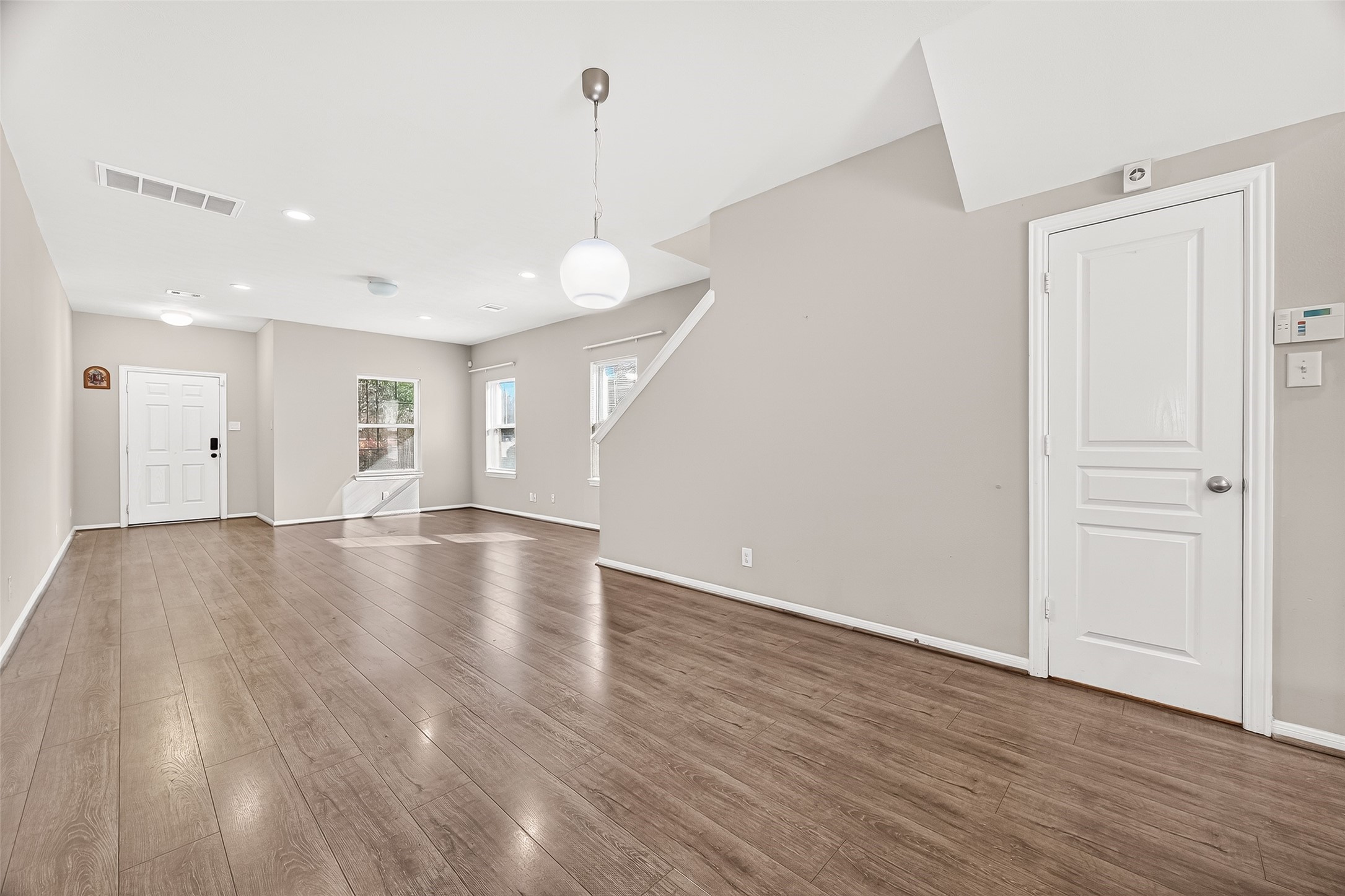 11211 Riata Canyon Drive Cypress, TX 77433 - Photo 5 of 33 a view of an empty room with wooden floor and a window