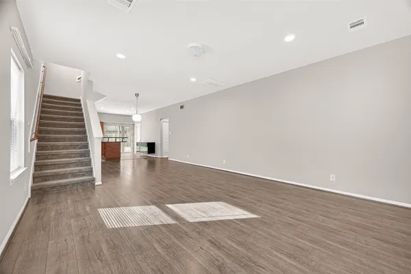 a bathroom with a tub sink vanity granite and a shower