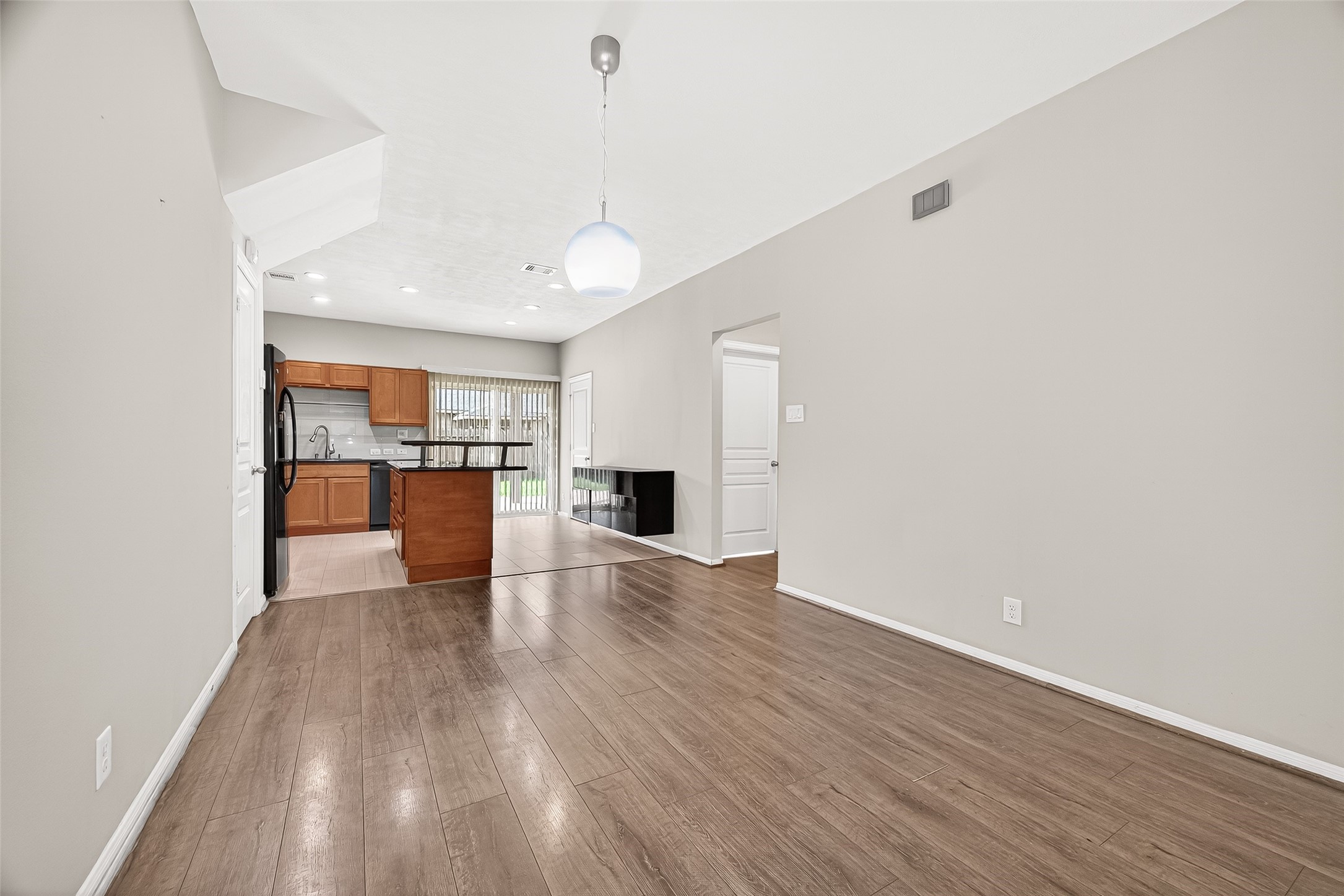 11211 Riata Canyon Drive Cypress, TX 77433 - Photo 7 of 33 a view of a kitchen with a sink and wooden floor