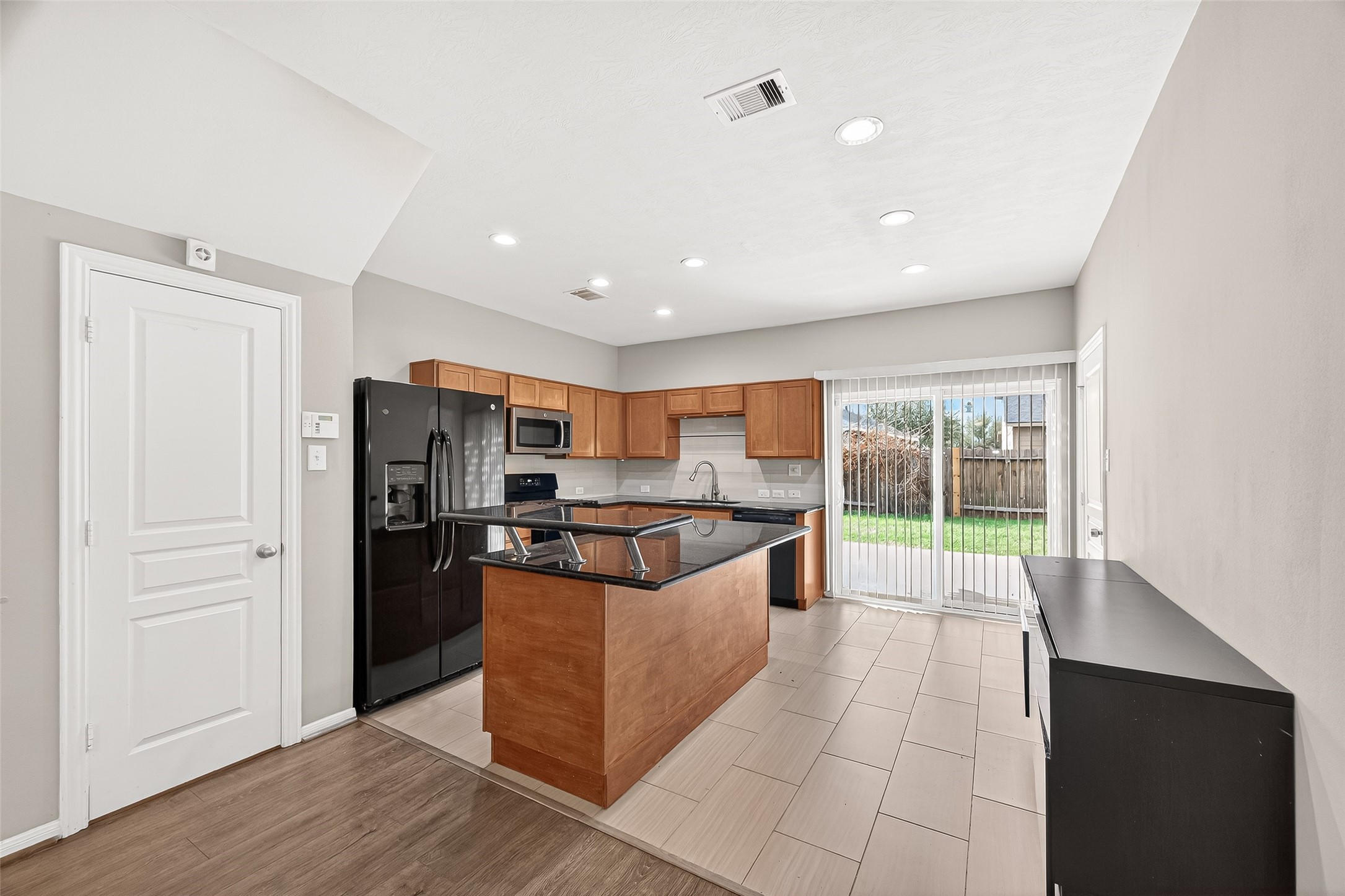 11211 Riata Canyon Drive Cypress, TX 77433 - Photo 8 of 33 a kitchen with stainless steel appliances granite countertop a stove a refrigerator a sink and a oven with wooden floor