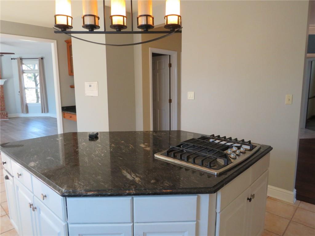304 Scenic Ridge Court Mars, PA 16046 - Photo 16 of 49 a kitchen with granite countertop a sink a stove and cabinets