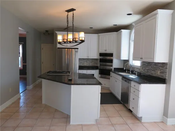 a kitchen with stainless steel appliances granite countertop a stove and a refrigerator