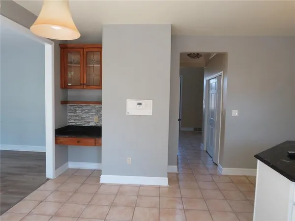 an empty room and an entrance to other room