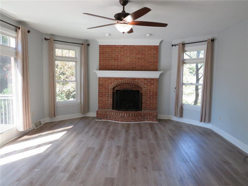 304 Scenic Ridge Court Mars, PA 16046 - Photo 20 of 49 a view of an empty room with wooden floor fireplace and a window