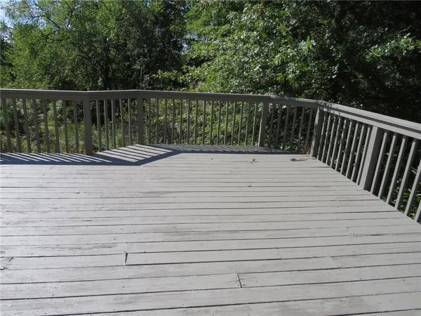 a balcony with wooden floor and fence