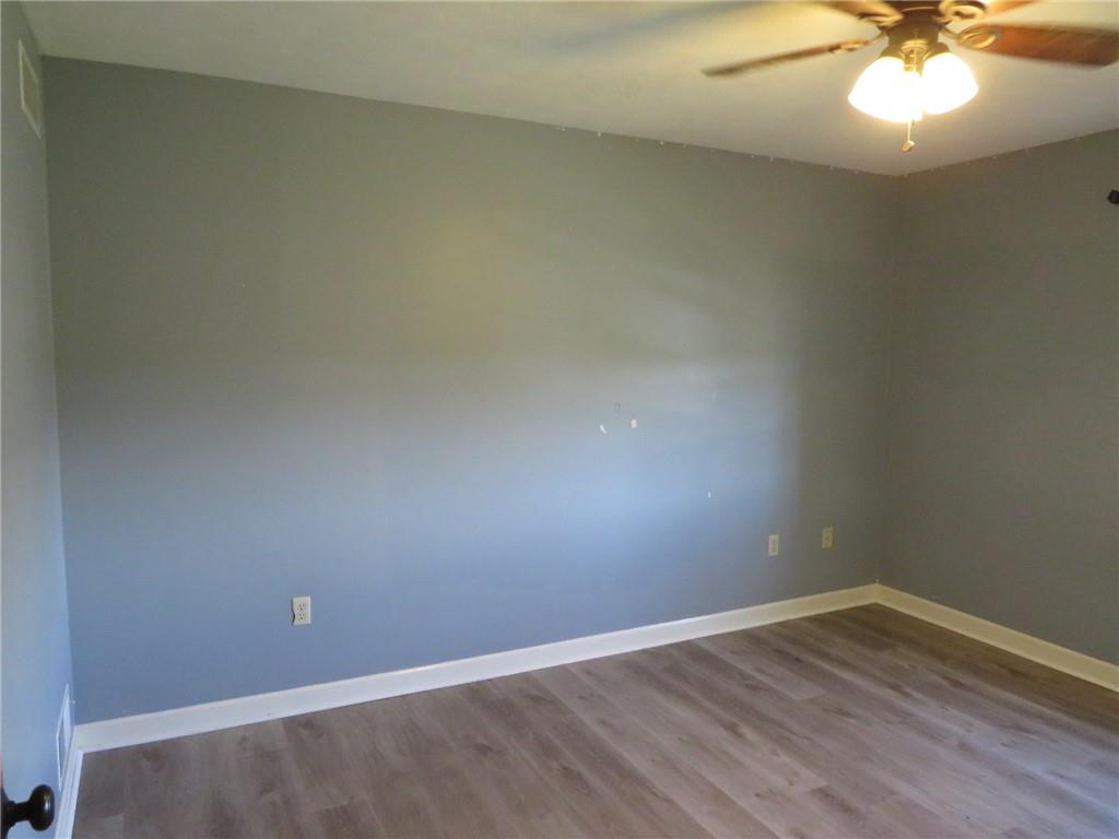 304 Scenic Ridge Court Mars, PA 16046 - Photo 35 of 49 an empty room with a chandelier fan and wooden floor