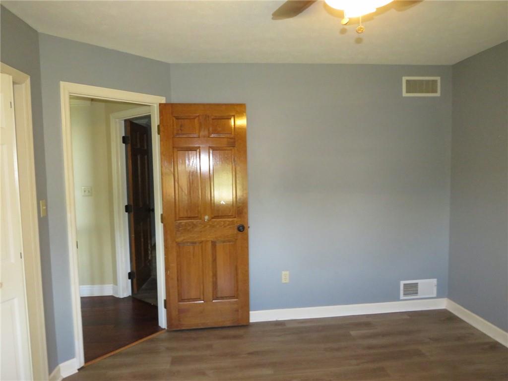 304 Scenic Ridge Court Mars, PA 16046 - Photo 38 of 49 a view of an empty room with wooden floor and a mirror