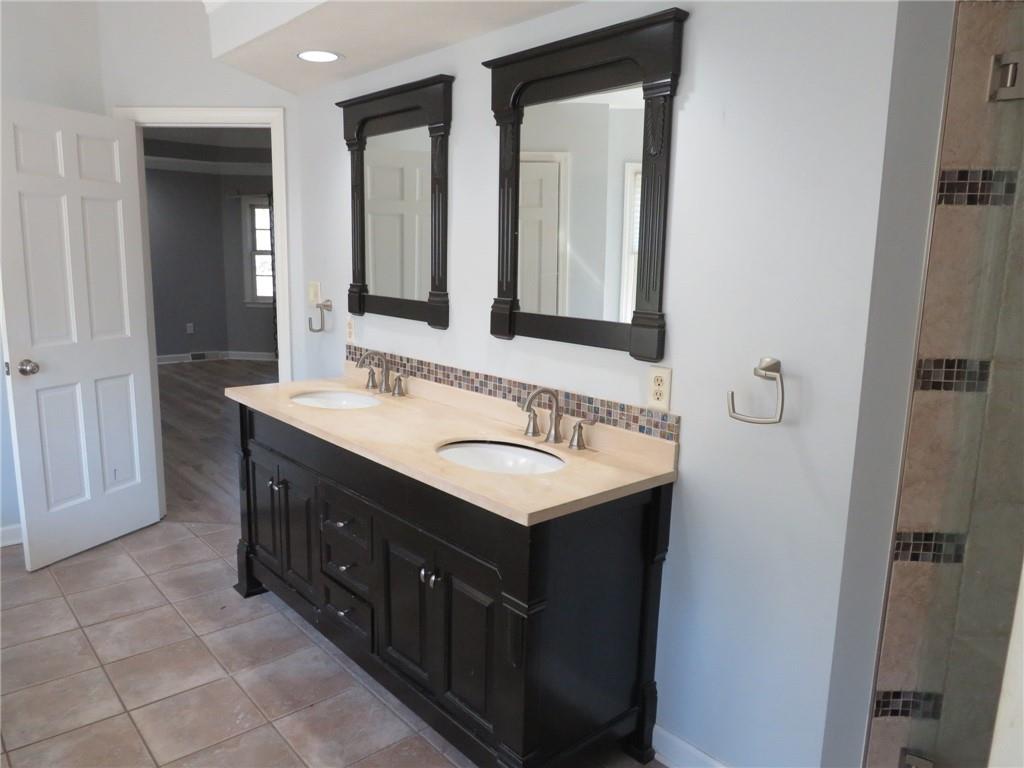 304 Scenic Ridge Court Mars, PA 16046 - Photo 46 of 49 a bathroom with a granite countertop sink and a mirror