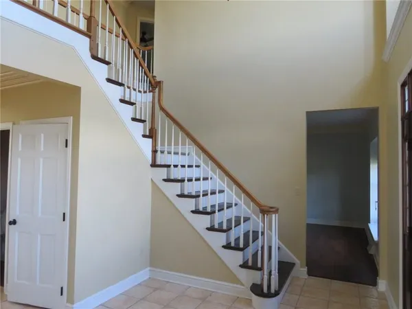 a view of entryway and hall with wooden floor