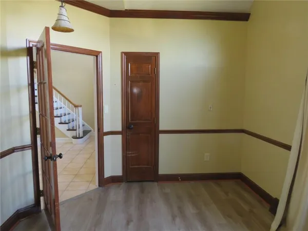 a view of walk in closet with wooden floor