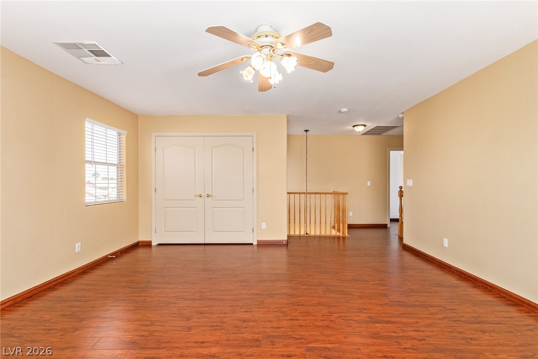 1477 Rancho Ridge Drive Henderson, NV 89012 - Photo 29 of 46 A versatile bonus room awaits, boasting rich wood flooring and abundant natural light.