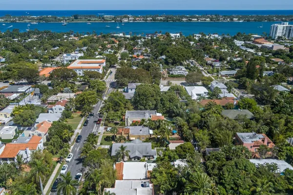 an aerial view of residential houses with outdoor space and trees