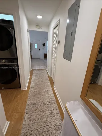 a view of hallway with stairs and wooden floor