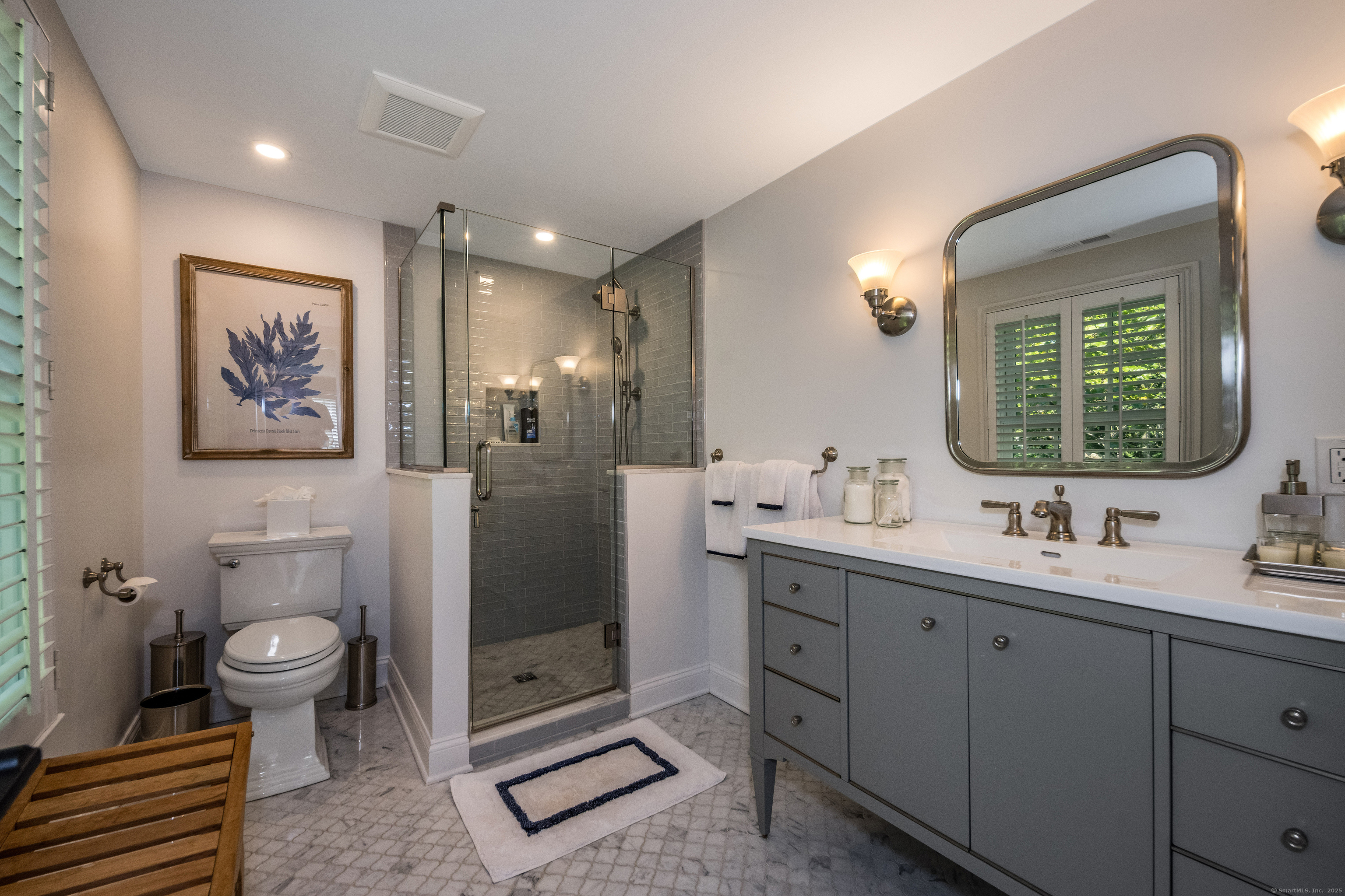 137 Liberty Street Madison, CT 06443 - Photo 18 of 40 a spacious bathroom with a toilet sink and mirror