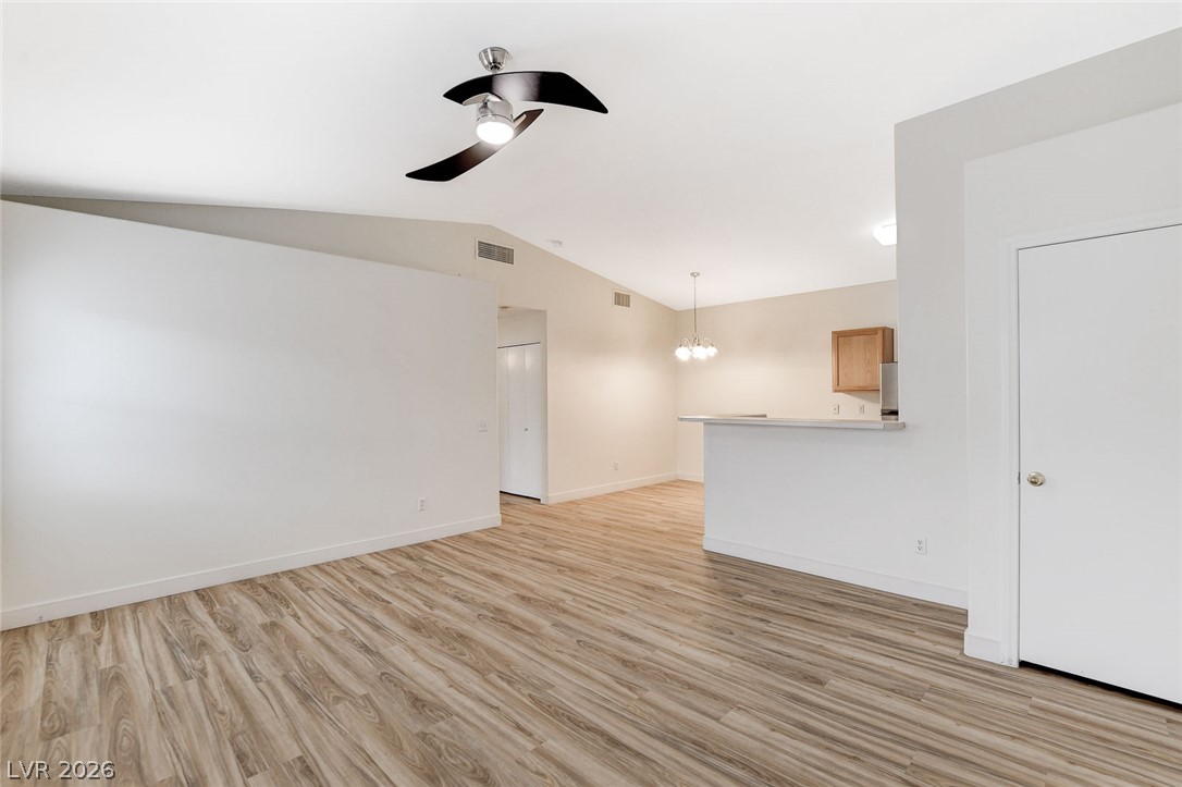 2052 Quarry Ridge Street, Unit 201 Las Vegas, NV 89117 - Photo 2 of 25 A well-lit, open-concept living space with sleek flooring and modern ceiling fan.