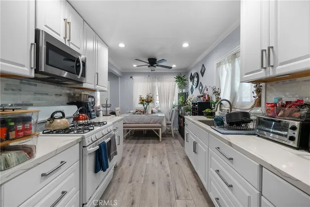 a kitchen with stainless steel appliances granite countertop lots of counter top space a sink and cabinets