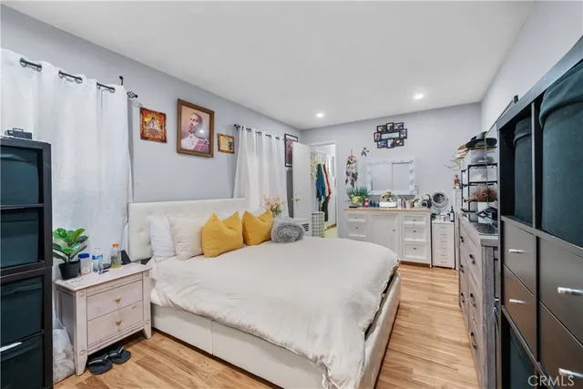 a bedroom with a bed flat screen tv and a window