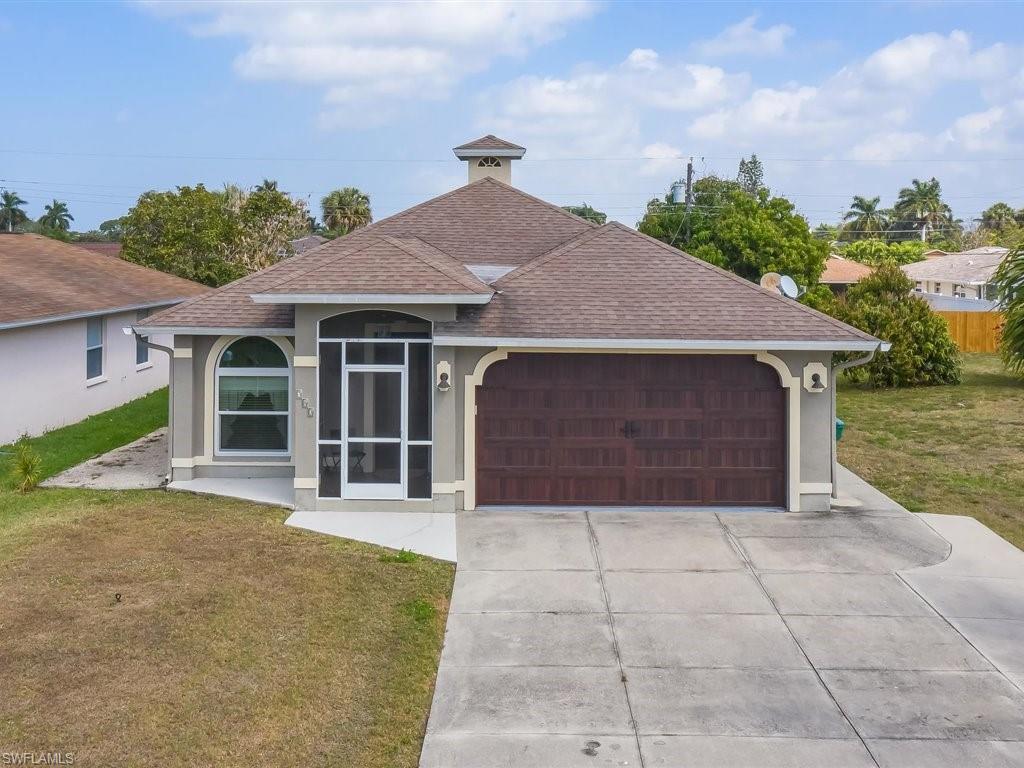 a front view of a house with a yard and garage
