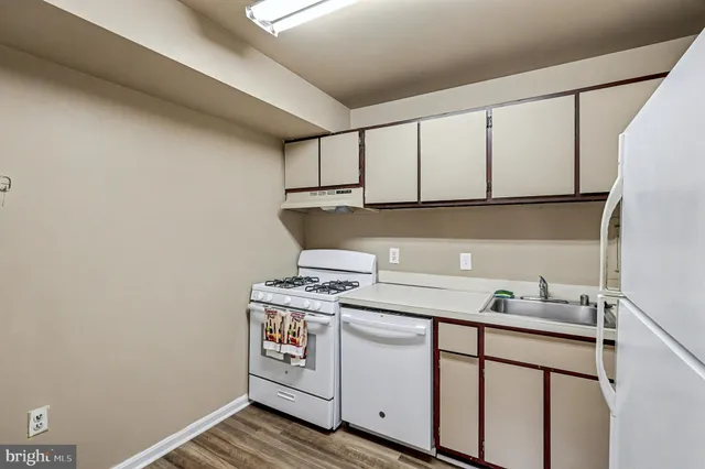 a kitchen with cabinets appliances and a sink