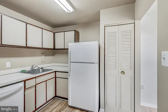 a white refrigerator freezer sitting inside of a kitchen