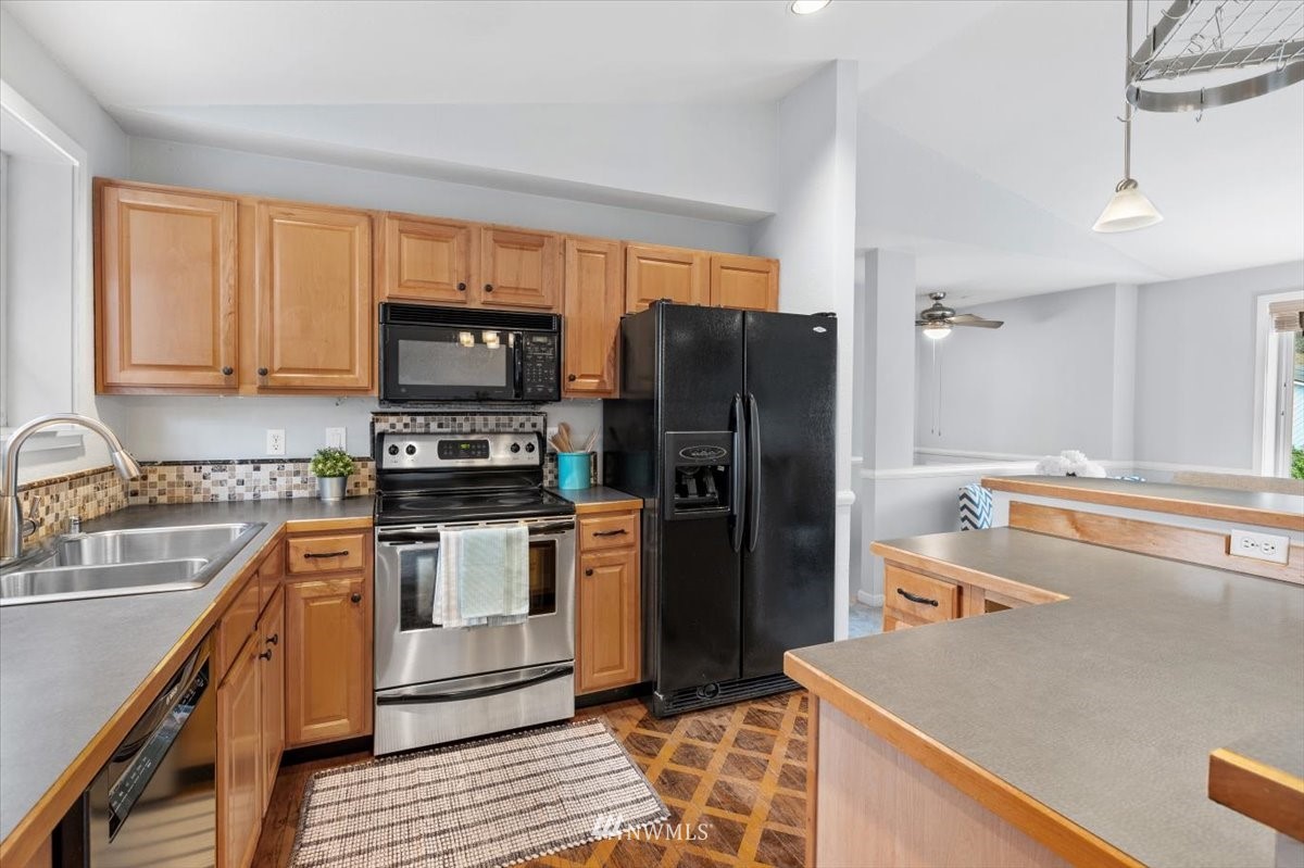 1723 225th Street Southeast Bothell, WA 98021 - Photo 11 of 40 a kitchen with stainless steel appliances granite countertop a refrigerator stove and sink