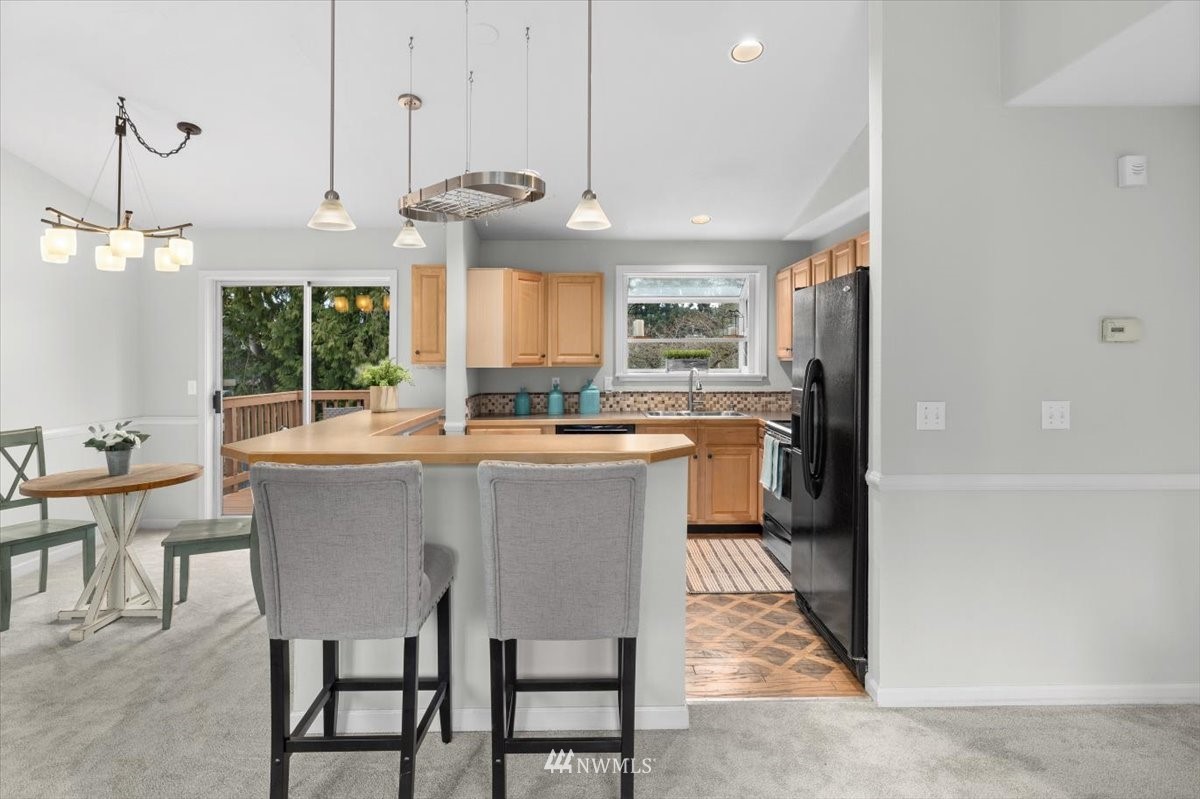 1723 225th Street Southeast Bothell, WA 98021 - Photo 13 of 40 a kitchen with kitchen island a large counter top space appliances and cabinets